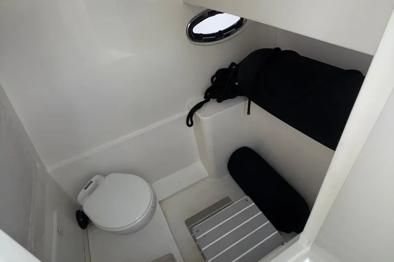 Slide: The Image of 2021 Marlin 39 CC boat interior with compact toilet and storage area. - 43