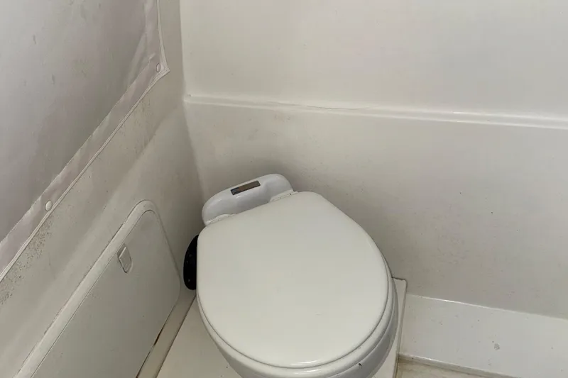 Slide: The Image of 2021 Marlin 39 CC boat bathroom with compact white toilet. - 44