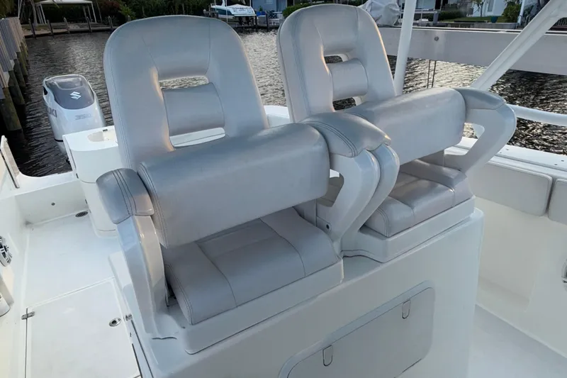 Slide: The Image of 2021 Marlin 39 CC boat with dual white captain's chairs and Suzuki outboard motor. - 46