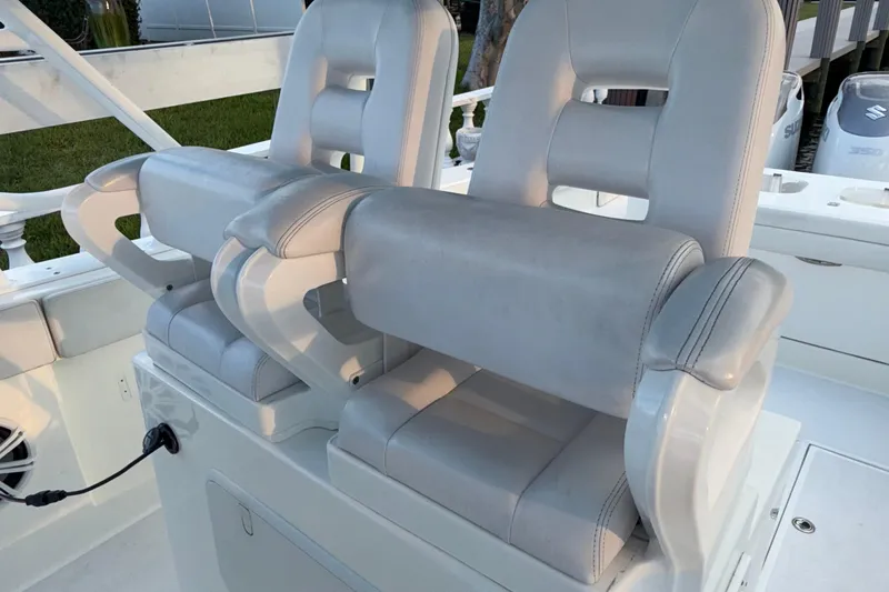 Slide: The Image of Luxury seating on 2021 Marlin 39 CC boat, featuring plush white upholstery. - 49