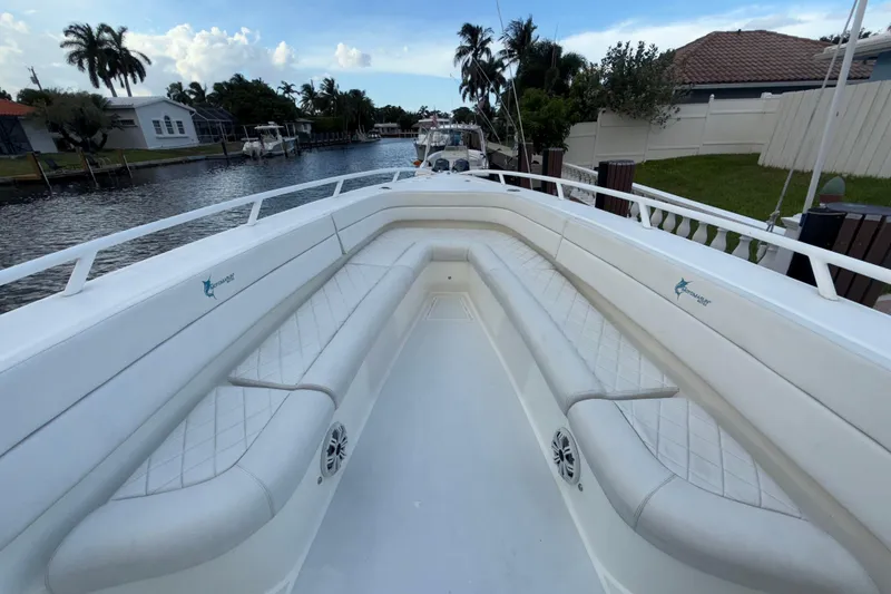 Slide: The Image of 2021 Marlin 39 CC boat with spacious seating, docked by a canal. - 51