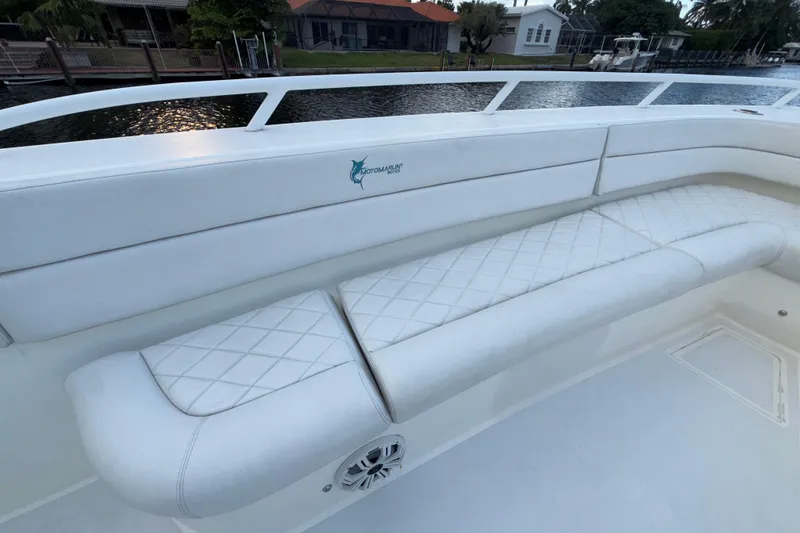 Slide: The Image of 2021 Marlin 39 CC boat with white cushioned seating and diamond pattern design. - 52