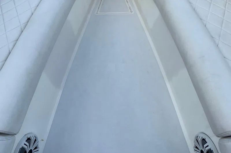 Slide: The Image of 2021 Marlin 39 CC boat interior with white cushioned seating and speakers. - 55