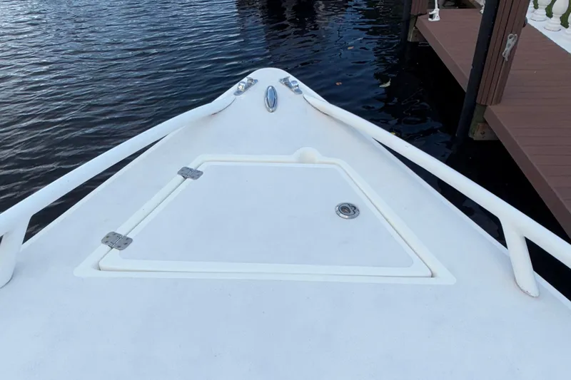 Slide: The Image of Bow of 2021 Marlin 39 CC boat docked by the water. - 56
