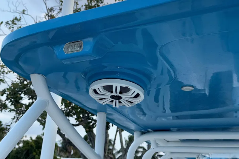 Slide: The Image of 2021 Marlin 39 CC boat with blue canopy and mounted speaker. - 59