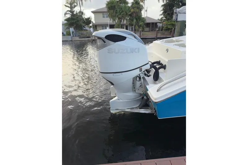Slide: The Image of 2021 Marlin 39 CC boat with Suzuki outboard motor docked by waterfront. - 64
