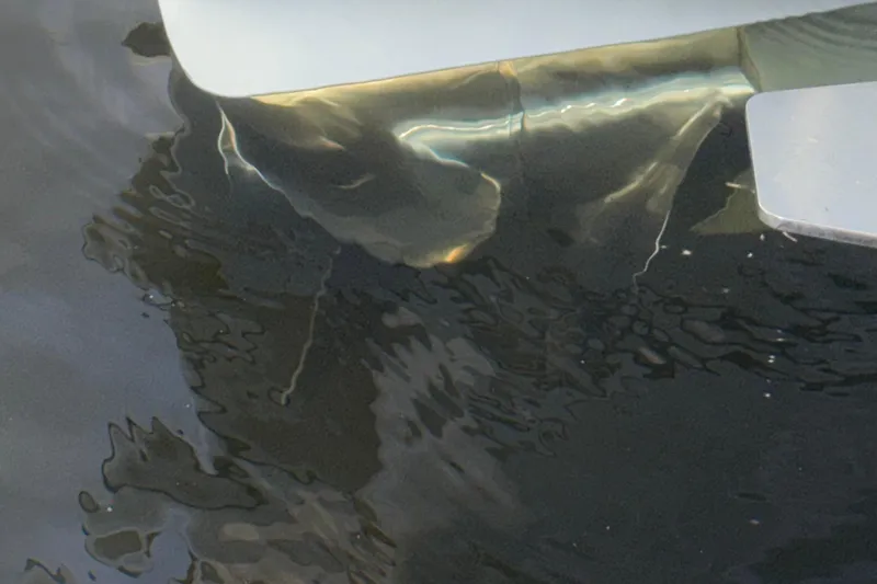 Slide: The Image of 2021 Marlin 39 CC boat hull reflecting in water. - 66