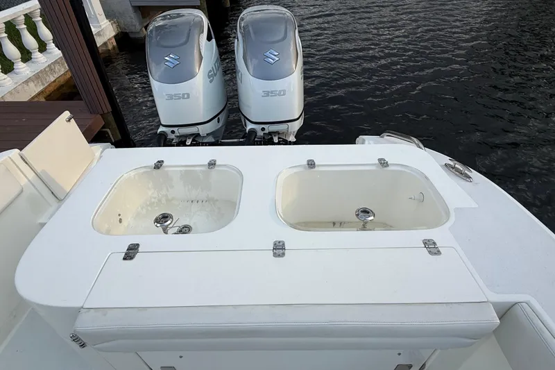 Slide: The Image of 2021 Marlin 39 CC boat with dual Suzuki 350 engines and livewell compartments. - 7