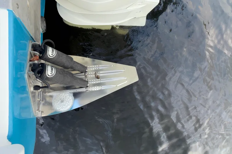 Slide: The Image of 2021 Marlin 39 CC boat trim tabs and motor in water. - 74