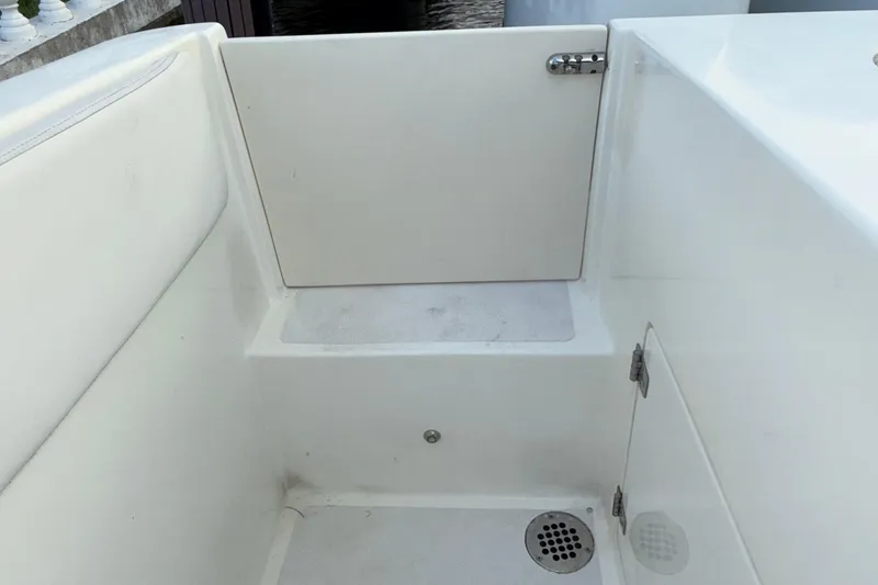 Slide: The Image of 2021 Marlin 39 CC boat interior with white seating and drainage area. - 75