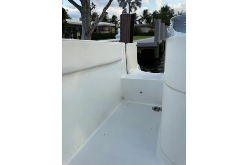 Slide: The Image of 2021 Marlin 39 CC boat deck with clean white surface and dock view. - 9