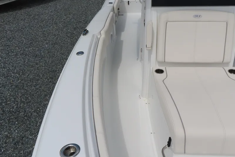 Slide: The Image of 2024 Sea Hunt Gamefish 30 Coffin Box boat interior with white seating and cup holders. - 10