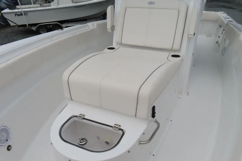 Slide: The Image of 2024 Sea Hunt Gamefish 30 Coffin Box boat interior with cushioned seating and storage. - 11