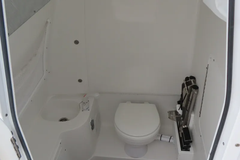 Slide: The Image of 2024 Sea Hunt Gamefish 30 Coffin Box boat interior with toilet and sink. - 16