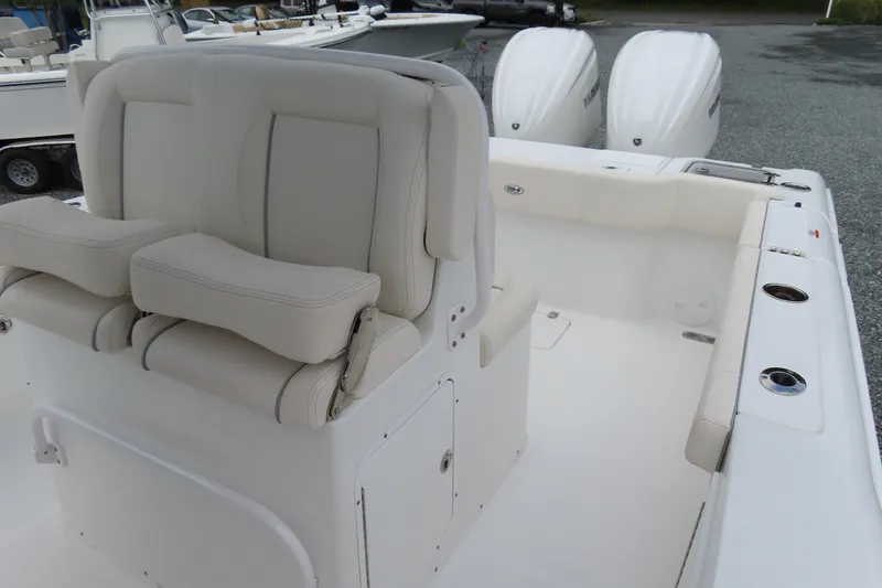 Slide: The Image of 2024 Sea Hunt Gamefish 30 Coffin Box boat interior with seating and dual engines. - 17