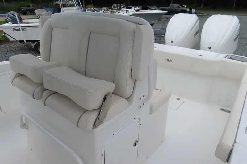Slide: The Image of 2024 Sea Hunt Gamefish 30 Coffin Box boat interior with cushioned seating and dual engines. - 18