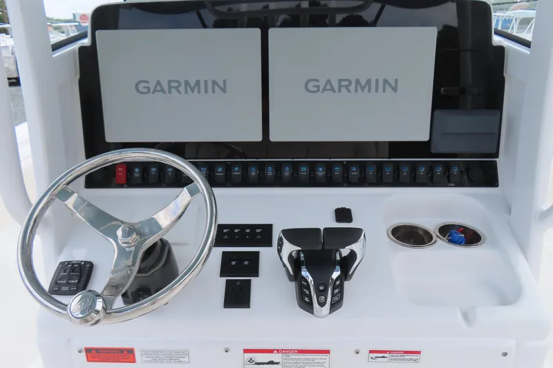 Slide: The Image of 2024 Sea Hunt Gamefish 30 Coffin Box dashboard with Garmin displays and steering wheel. - 20