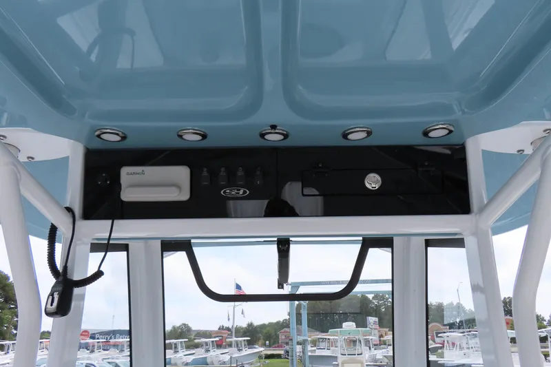 Slide: The Image of 2024 Sea Hunt Gamefish 30 Coffin Box helm with Garmin electronics and overhead lighting. - 23