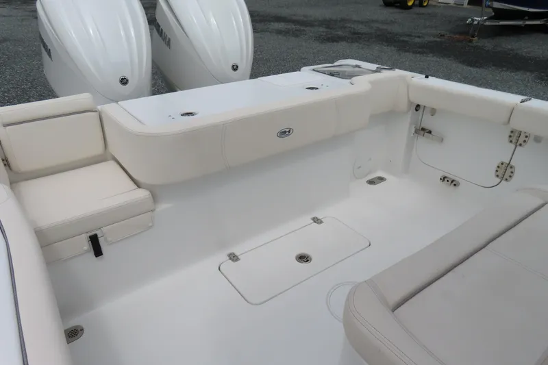 Slide: The Image of 2024 Sea Hunt Gamefish 30 Coffin Box boat interior with seating and dual engines. - 24