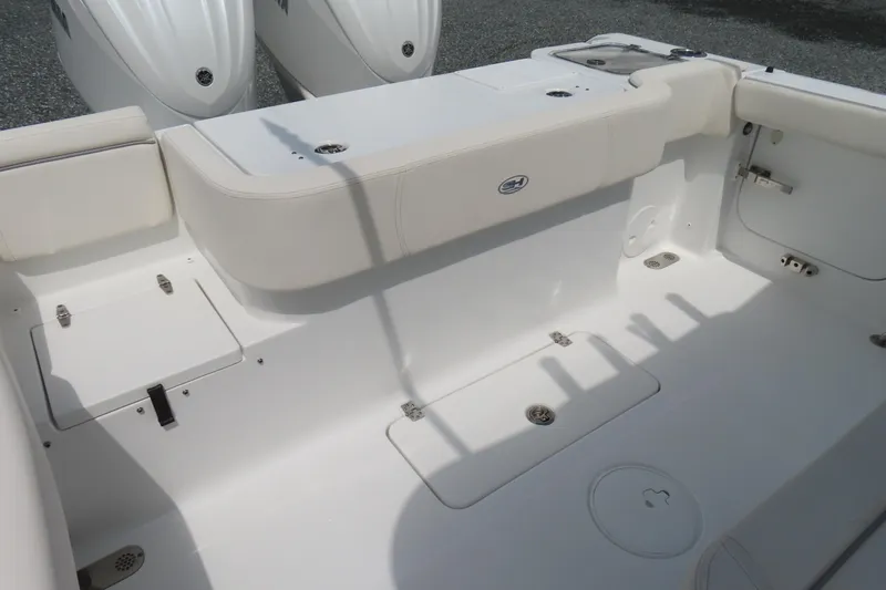 Slide: The Image of 2024 Sea Hunt Gamefish 30 Coffin Box boat interior, featuring spacious seating and storage. - 28
