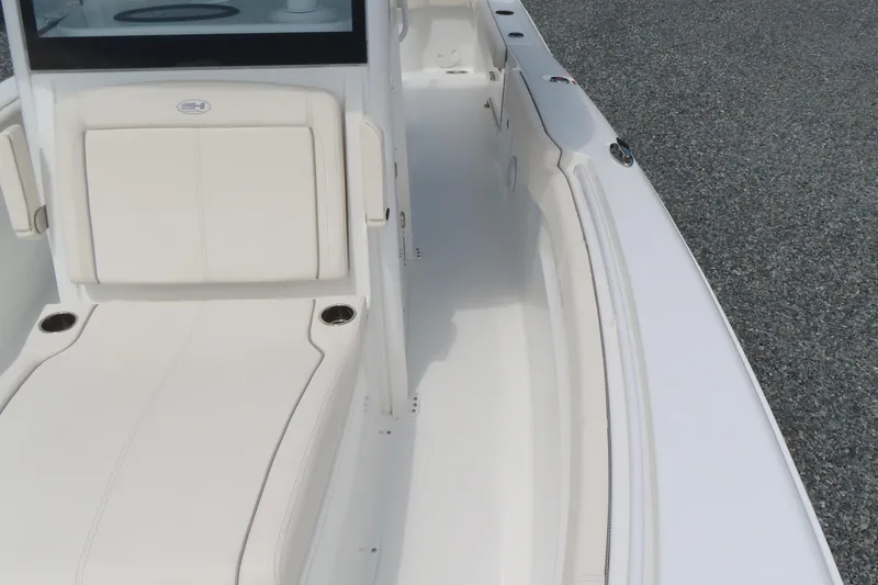 Slide: The Image of 2024 Sea Hunt Gamefish 30 Coffin Box boat interior with white seating and spacious deck. - 9