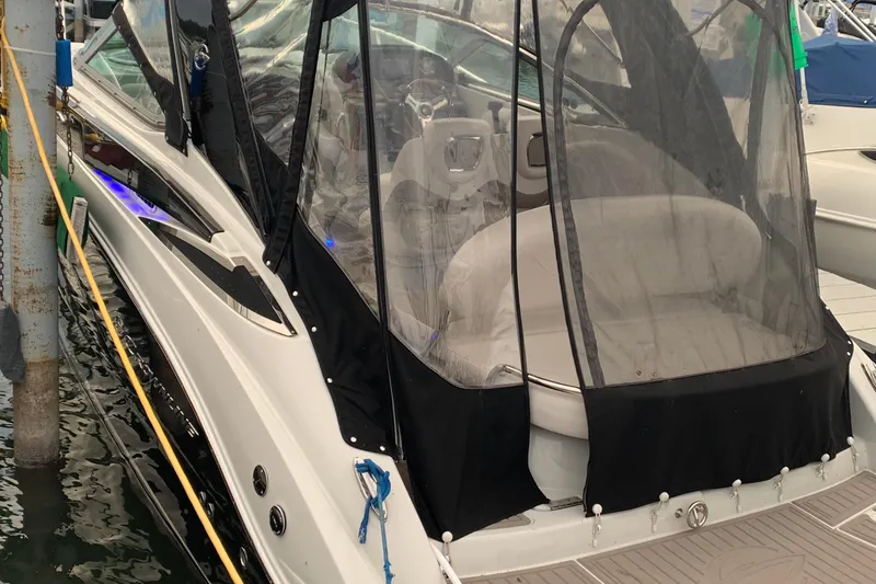 Slide: The Image of 2018 Crownline 264 CR boat docked with protective canopy. - 2