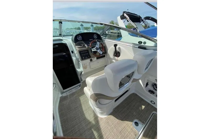 Slide: The Image of 2018 Crownline 264 CR boat interior with steering wheel and control panel. - 5
