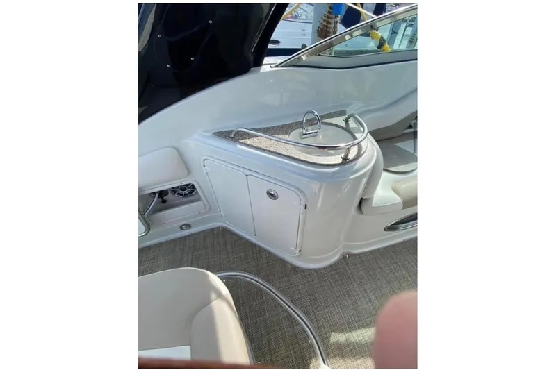 Slide: The Image of 2018 Crownline 264 CR boat interior with sink and storage area. - 9