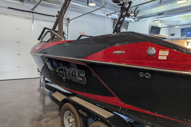 Slide: The Image of 2018 Axis T23 boat in showroom, black and red design, on trailer. - 15
