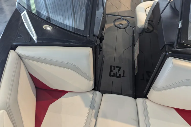 Slide: The Image of 2018 Axis T23 boat interior with white and red seating, black flooring. - 21