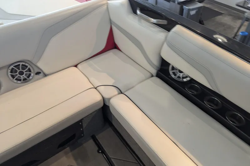 Slide: The Image of 2018 Axis T23 boat interior with white seating and built-in speakers. - 29