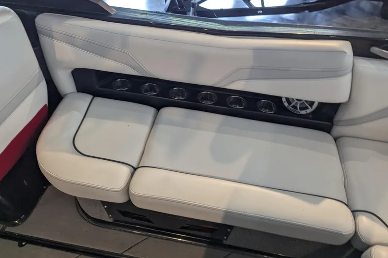 Slide: The Image of 2018 Axis T23 boat interior with white cushioned seating and built-in cup holders. - 30