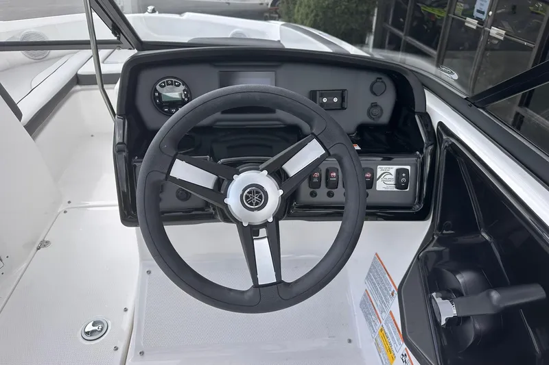 Slide: The Image of 2025 Yamaha Boats AR190 steering wheel and dashboard interior view. - 12
