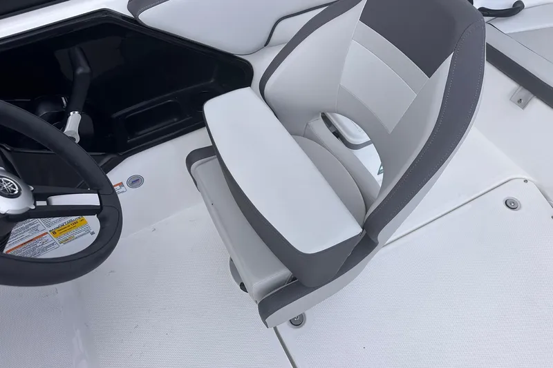 Slide: The Image of 2025 Yamaha Boats AR190 cockpit with steering wheel and cushioned seat. - 18