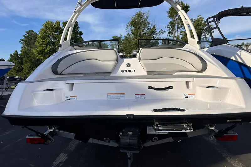 Slide: The Image of 2025 Yamaha Boats AR190, rear view, showcasing sleek design and seating, outdoors. - 5