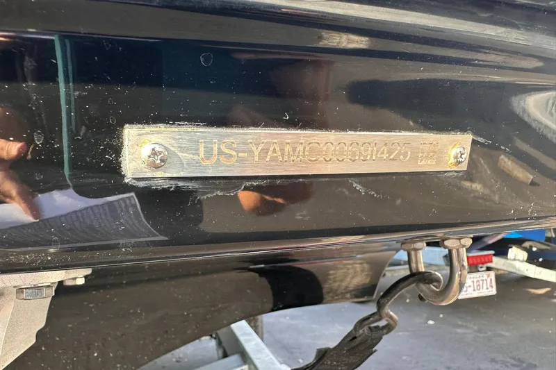 Slide: The Image of 2025 Yamaha Boats AR190 hull identification number plate on a black surface. - 6