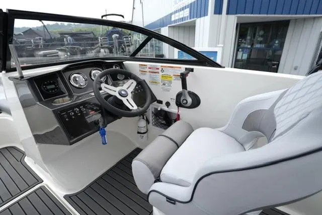 Slide: The Image of 2024 Bayliner VR5 Bowrider I/O cockpit with steering wheel and comfortable seating. - 13