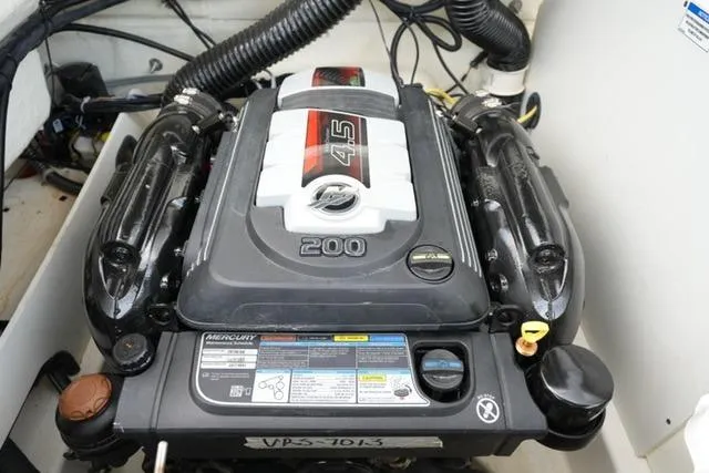 Slide: The Image of 2024 Bayliner VR5 Bowrider I/O engine compartment with Mercury 4.5L 200 HP motor. - 17