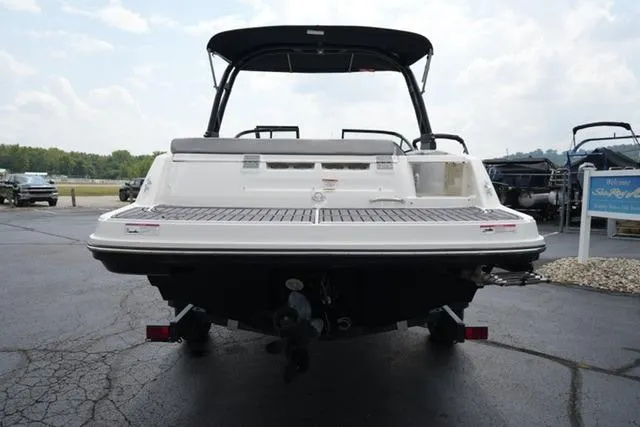 Slide: The Image of 2024 Bayliner VR5 Bowrider I/O boat, rear view, parked on asphalt, showcasing swim platform. - 6