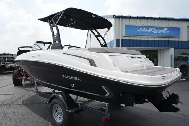 Slide: The Image of 2024 Bayliner VR5 Bowrider I/O boat on trailer, parked outside dealership. - 7