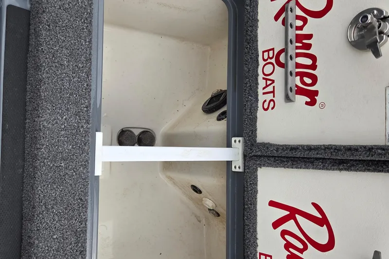 Slide: The Image of Open storage compartment in 2022 Ranger Z520R boat with carpeted interior. - 12