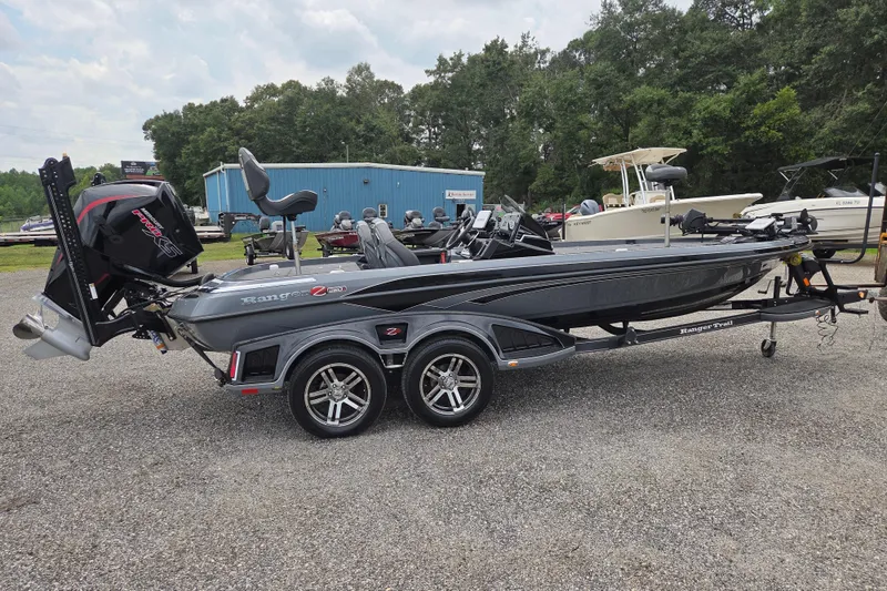 Slide: The Image of 2022 Ranger Z520R bass boat on trailer, parked outdoors with other boats nearby. - 4