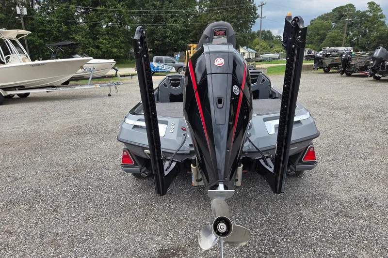 Slide: The Image of 2022 Ranger Z520R boat with powerful outboard motor, parked on gravel lot. - 6