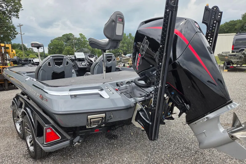 Slide: The Image of 2022 Ranger Z520R boat with powerful outboard motor, parked on gravel lot. - 7