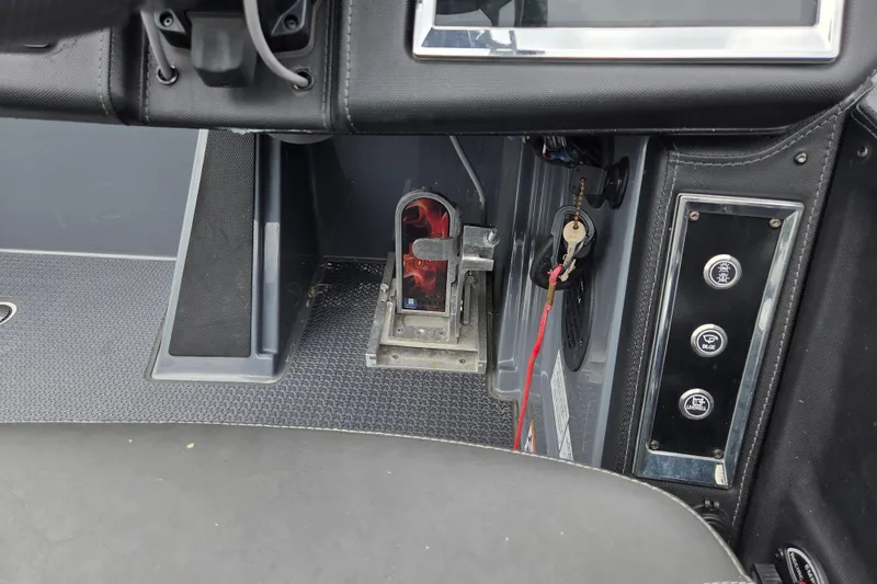 Slide: The Image of 2022 Ranger Z520R boat dashboard with key ignition and control panel. - 9