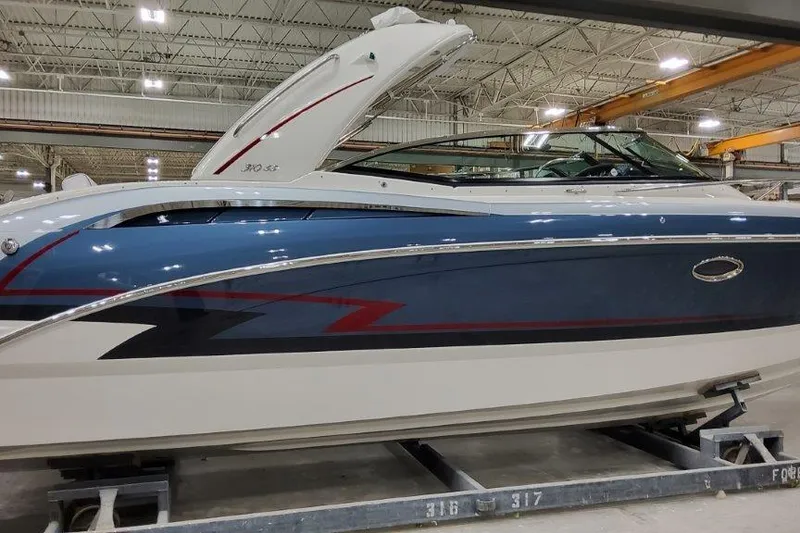The Image of 2024 Formula 310 Sun Sport boat in a showroom, featuring sleek blue and white design. - 0
