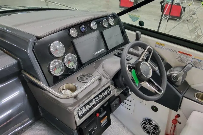 Slide: The Image of 2024 Formula 310 Sun Sport dashboard with steering wheel and control panel. - 10