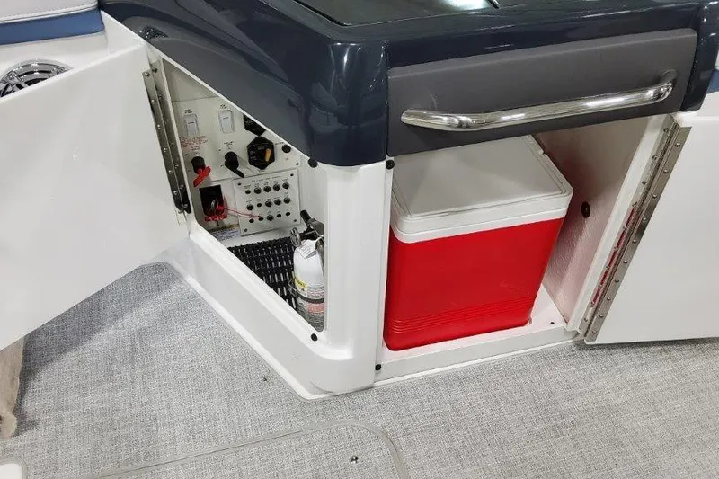 Slide: The Image of 2024 Formula 310 Sun Sport boat interior with storage compartment and red cooler. - 14