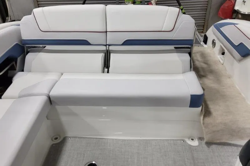 Slide: The Image of 2024 Formula 310 Sun Sport boat interior with white and blue seating. - 18