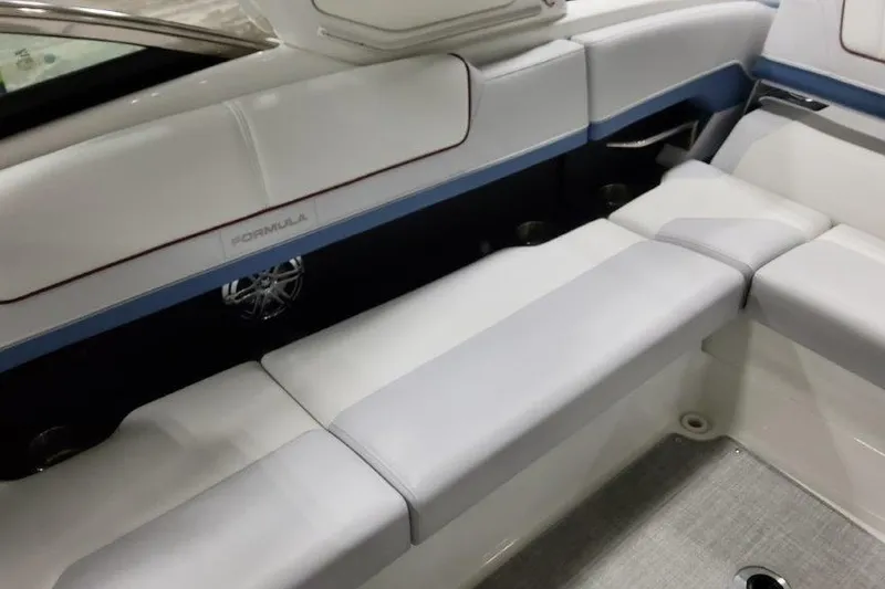 Slide: The Image of 2024 Formula 310 Sun Sport boat interior with white and blue seating. - 19